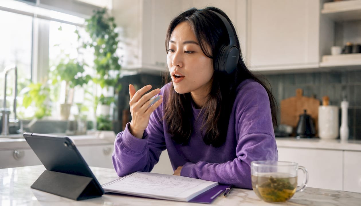 Woman practicing connected speech with headphones