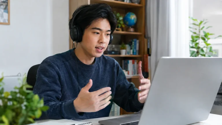 Young man speaking in an online English lesson with headphones - ESL: Fix 60–80 ms Aspiration in English to Be Understood