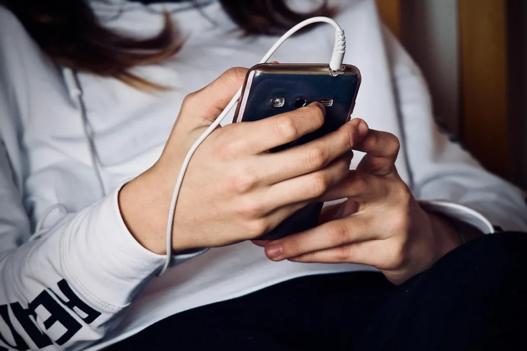 Woman, mobile phone, listening to music - InPronunci AI Accent Coach: Pronunciation Feedback for Professional Clarity