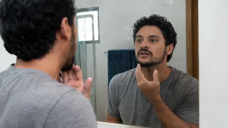 Man practicing pronunciation at a mirror - Tongue Placement in English Sounds