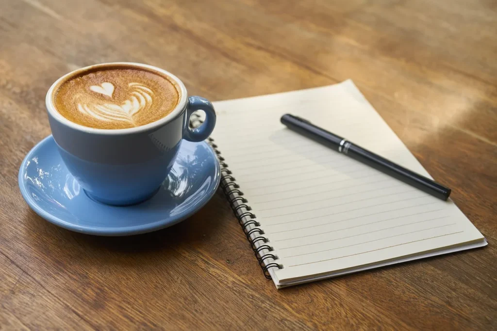 Coffee, pen, notebook - Why Daily Pronunciation Practice Matters