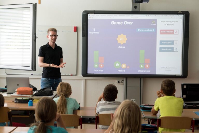 ESL teacher teaching pronunciation in front of a class with an interactive whiteboard